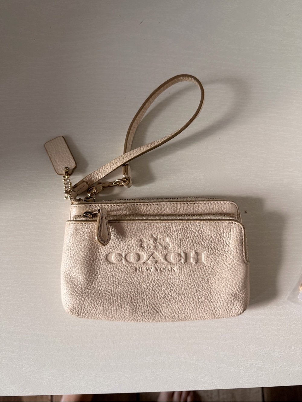Coach Double Corner Zip Wristlet crafted from textured pebble leather.